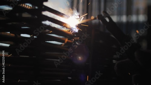 Welding of metal reinforcement on the construction site. Sparks from welding. photo