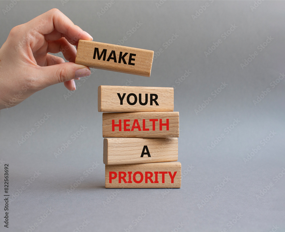 Health symbol. Wooden blocks with words Make your health a Priority ...