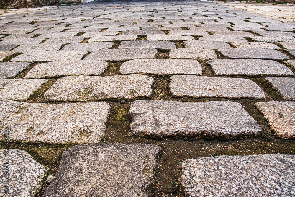 Stone paving stones close-up, European stone road Stone paving stones close-up, European stone road