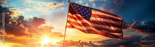 Beautiful image of an American flag waving against a vibrant sunset sky, perfect for patriotic celebrations like Independence Day and Fourth of July. photo