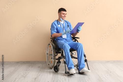 Young male doctor in wheelc...