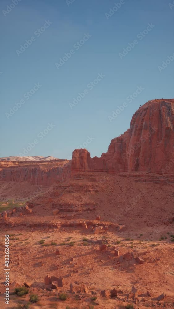 A large rock formation stands prominently in the vast Nevada desert landscape under the scorching sun. A large rock formation stands prominently in the vast Nevada desert landscape under the scorching sun.