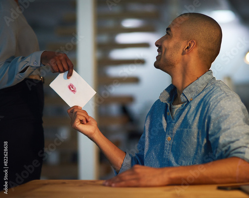 Smile, man and letter for love in office romance, coworking and secret admirer in startup business. Flirting, employee and giving note, gift or hand offer paper card with kiss for message at work