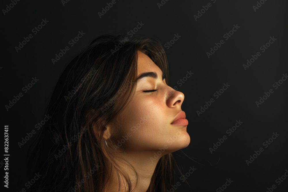A close up of a woman 's face with her eyes closed A close up of a woman 's face with her eyes closed