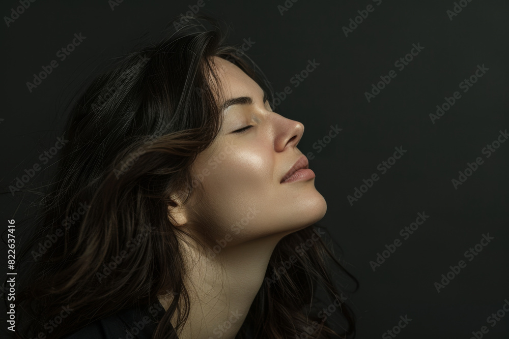 A close up of a woman 's face with her eyes closed A close up of a woman 's face with her eyes closed
