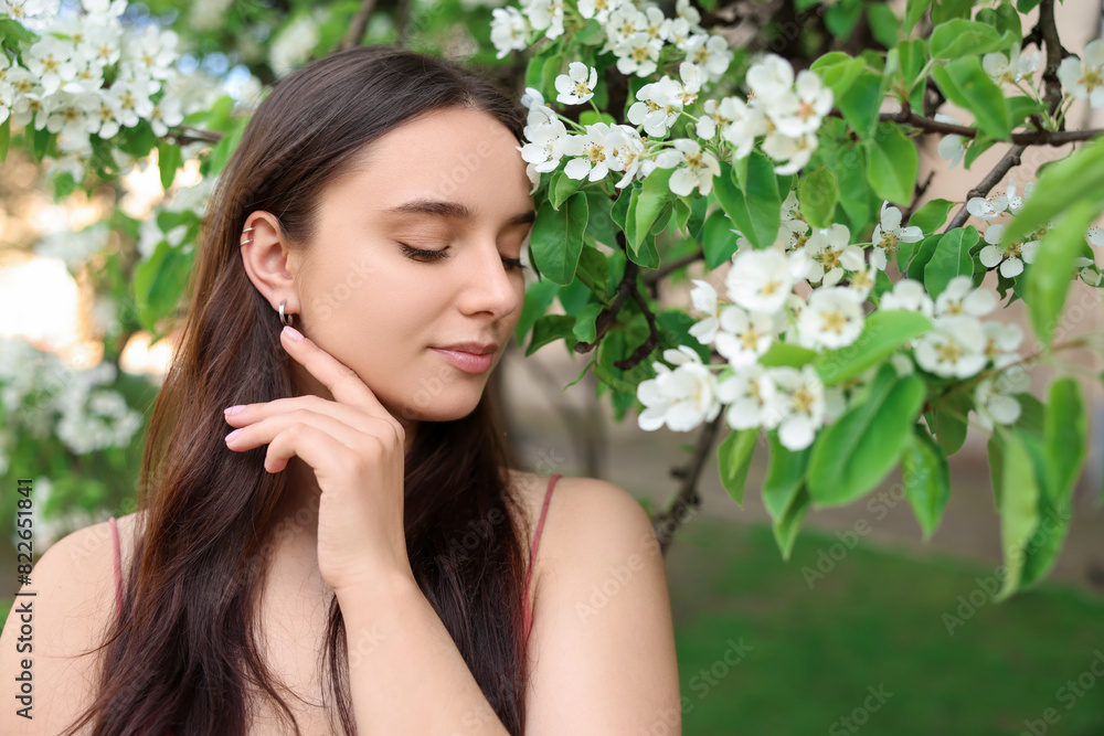Beautiful woman near blossoming tree on spring day Beautiful woman near blossoming tree on spring day