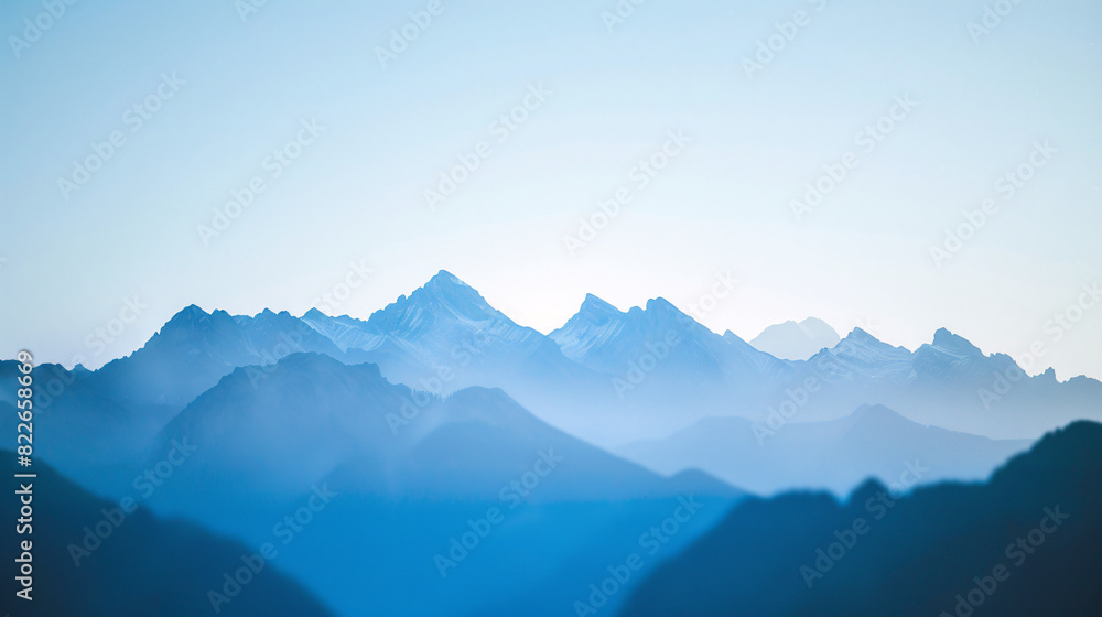 Blue mountain range landscape. Stunning blue toned landscape photo of a mountain range with hazy peaks. Ideal for travel, nature, and outdoor projects.