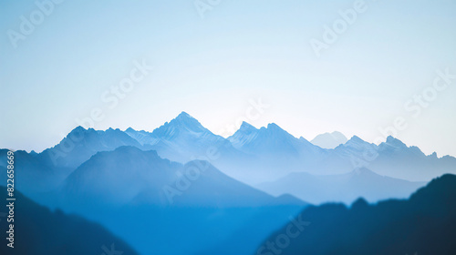 Blue mountain range landscape. Stunning blue toned landscape photo of a mountain range with hazy peaks. Ideal for travel, nature, and outdoor projects. © kosarit