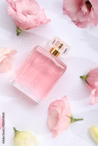 Luxury perfume and floral decor on white background  flat lay