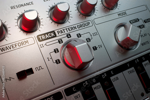 Tableau sur toile 1980’s analog bass synthesizer in music studio showing track pattern group controls, waveform switch and mode, silver with a red tint