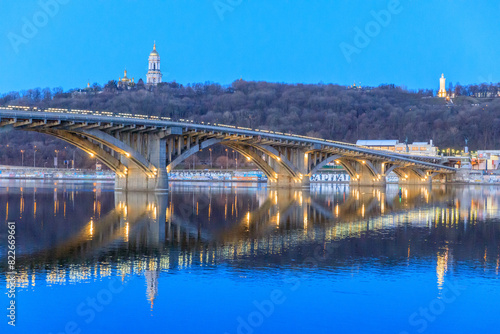 Ukraine, Kiev, Kyiv. Metro Bridge across the Dnieper River. Roofs of Monastery of the Caves (Pechersk Lavra) in the background. photo