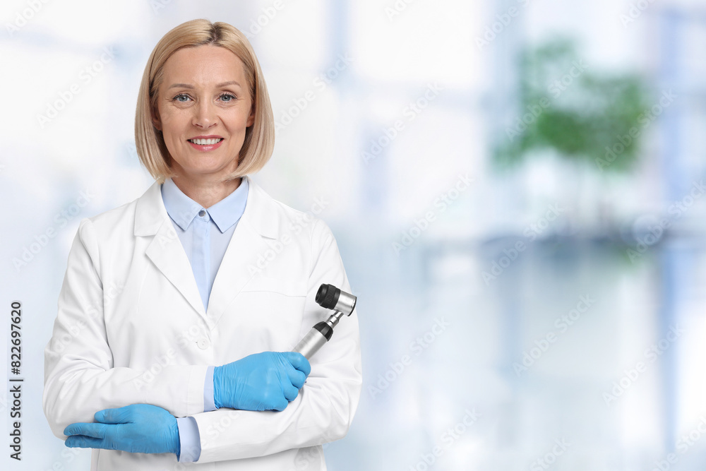 Professional dermatologist with dermatoscope on blurred background, space for text Professional dermatologist with dermatoscope on blurred background, space for text