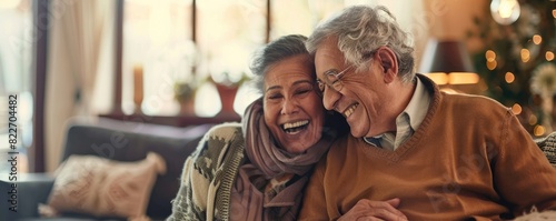 Senior couple laughing together in a cozy home setting, exuding warmth and happiness, with soft lighting and festive decorations in the background.