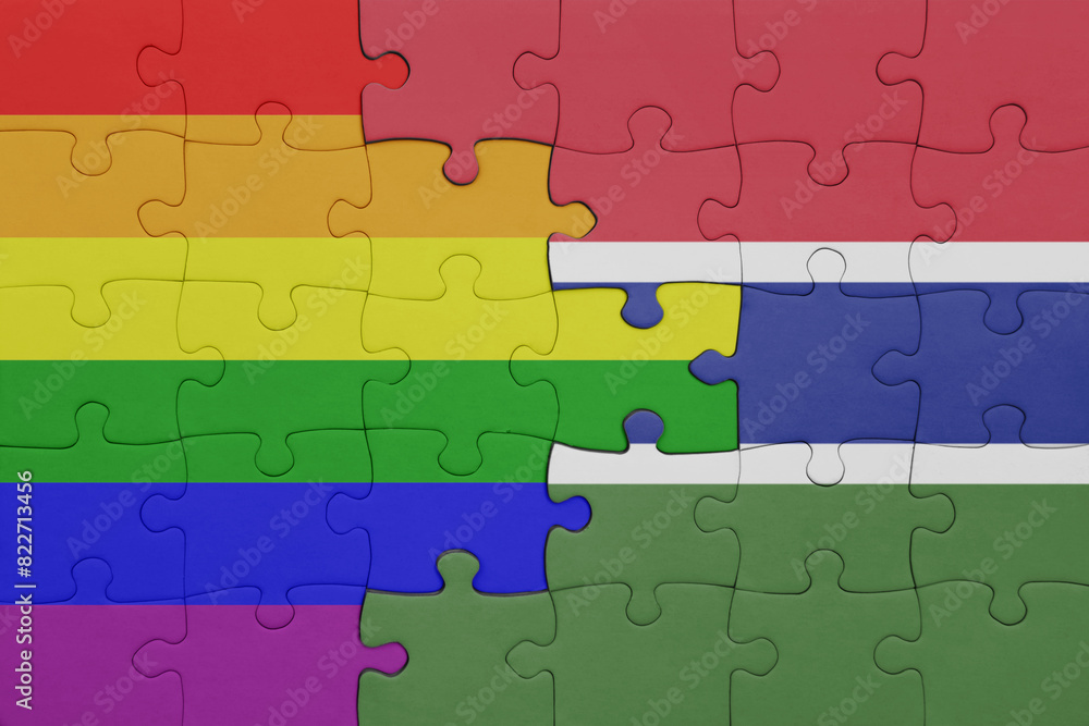 puzzle with the colourful national flag of gambia and rainbow gay pride flag . puzzle with the colourful national flag of gambia and rainbow gay pride flag .