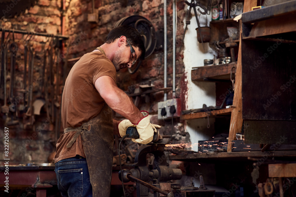 Man, blacksmith and welding sparks or metal production in warehouse as manufacturing, factory or handyman. Male person, tools and remodeling creativity or small business restoration, project or steel Man, blacksmith and welding sparks or metal production in warehouse as manufacturing, factory or handyman. Male person, tools and remodeling creativity or small business restoration, project or steel