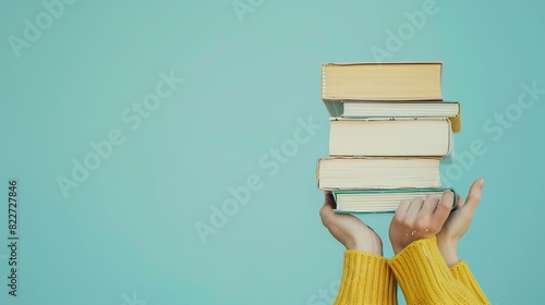Female hands holding pile of books over light blue background Education selflearning book swap hobby relax time : Generative AI photo