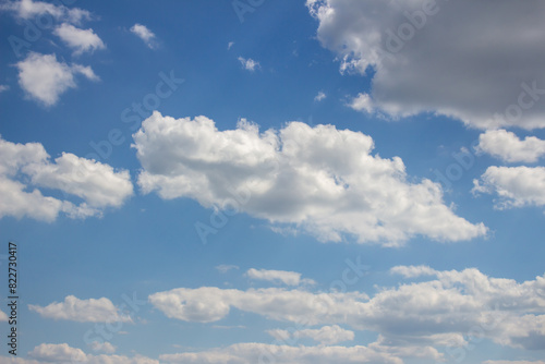 Cumulus clouds in the blue sky.