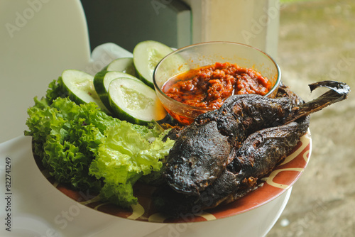 Lele goreng or Fried Catfish is a traditional Indonesian culinary food. Lele tomato and chili paste, popular street snack named Pecel Lele Lamongan.