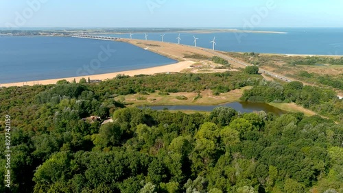 4K drone view of wind turbines and a dam in The Netherlands countryside. photo