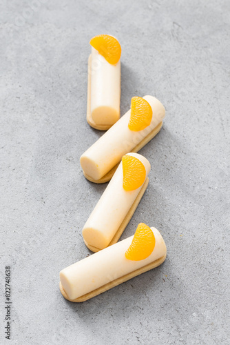 Tangerine cream dessert bars. On cookies. Decorated with a slice of tangerine