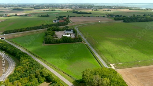 Turning aerial view of crop fields and secondary roads in rural area in The Netherlands.