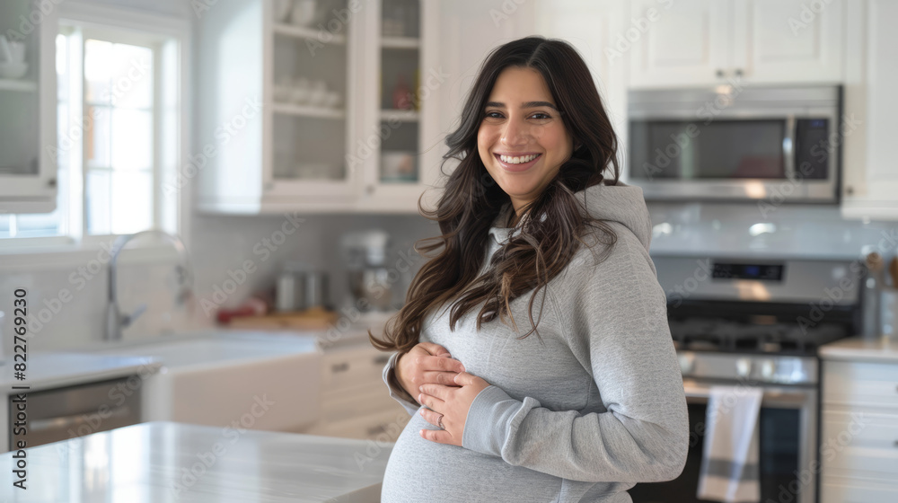 Happy Pregnant Woman Standing in Kitchen