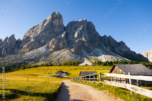 Countryside view of Dolomites mountains. Houses in mountains against Munt de Fornella, South Tyrol, Italy, Europe photo