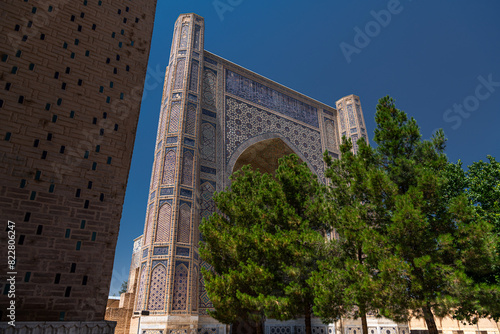 Samarkand Bibi Khanym mosque behind the pine trees, Uzbekistan photo