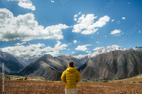 latin hiker observing the mountains and the andes mountain range. photo