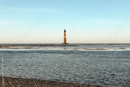 Morris Island Lighthouse from the shoreline of Folly Beach near Charleston, South Carolina.