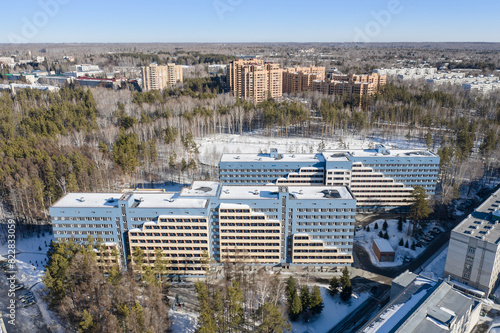 Aerial view of the new dormitories of Novosibirsk State University and other buildings in the middle of the forest in spring