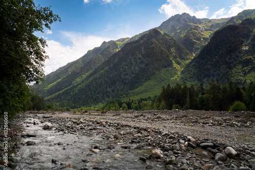 View of the Psysh riverbed in the northern foothills of the Caucasus Mountains near the village of Arkhyz on a sunny summer day, Karachay-Cherkessia, Russia photo