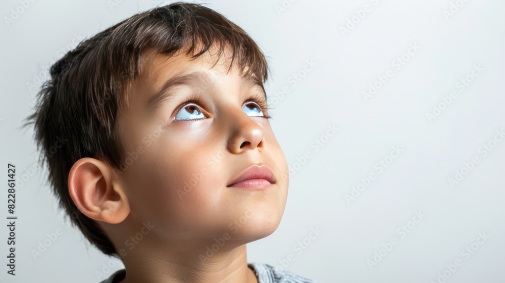 Close up of boy face head with Imagine and look up expression on white background. Close up of boy face head with Imagine and look up expression on white background.
