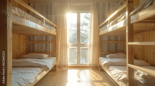 Cozy hostel room with wooden bunk beds bathed in morning sunlight