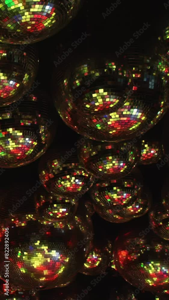 A colorful disco ball with purple and blue lights. The ball is surrounded by a dark background. Scene is energetic and fun, as it evokes the feeling of dancing and partying. A colorful disco ball with purple and blue lights. The ball is surrounded by a dark background. Scene is energetic and fun, as it evokes the feeling of dancing and partying.