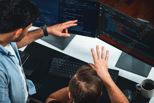 Obraz na płótnie IT developers discussing online software development information on pc screen, creating program coding for latest version application on website. Concept of brainstorming firmware updated. Sellable.