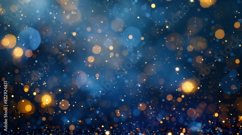 Elegant abstract background featuring dark blue, gold particles, and Christmas light bokeh on a blue-green backdrop with gold foil © panu101