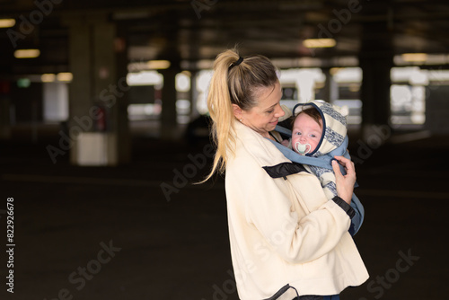 Sideview of a happy woman looking and smiling to her baby