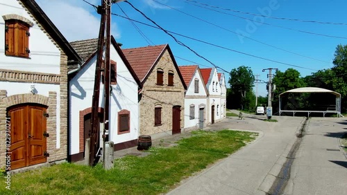 A row of charming historic buildings on a quiet sunny street in Hajos photo