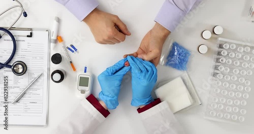 Doctor checks blood sugar level of patients top view photo