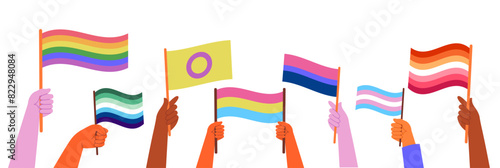 Hands holding LGBTQ sexual identity pride flags