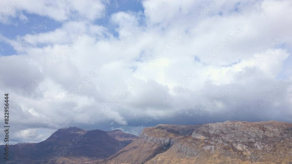 Mountains under a dramatic vast cloudy sky at Beinn Eighe in Scotland, aerial view Mountains under a dramatic vast cloudy sky at Beinn Eighe in Scotland, aerial view