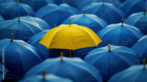 A yellow umbrella stands out from the crowd of blue umbrellas, symbolizing unique individuality and self-expression