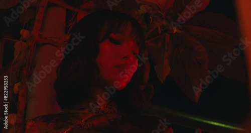 cinematic red light with asiatic woman female model girl portrait low angle photo