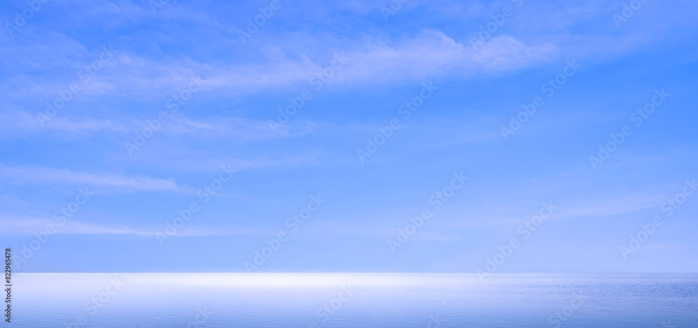 Panoramic blue sky background and clouds streak over sea with light reflection on water surface in the morning, Idyllic natural tranquil seascape view with copy space Panoramic blue sky background and clouds streak over sea with light reflection on water surface in the morning, Idyllic natural tranquil seascape view with copy space