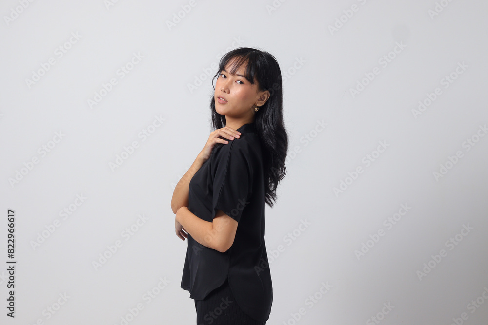 Portrait of attractive Asian woman in casual shirt feeling confident, posing with professional hand gesture. Isolated on white background Portrait of attractive Asian woman in casual shirt feeling confident, posing with professional hand gesture. Isolated on white background