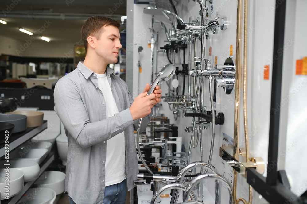 A buyer shopping for bathroom equipment in hardware store. Touching faucet crane or water tap A buyer shopping for bathroom equipment in hardware store. Touching faucet crane or water tap