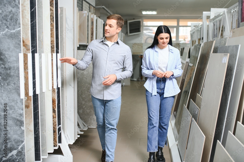 Beautiful young couple choosing ceramic tiles