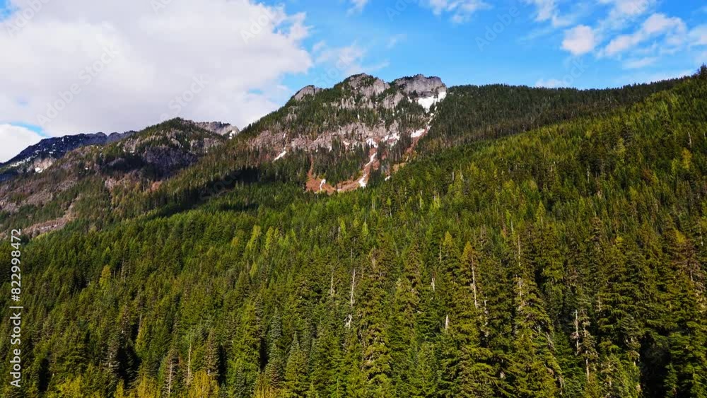 Beautiful Aerial view flying over Evergreen forest towards a mountain at Gold Creek Pond in Washington State. Beautiful Aerial view flying over Evergreen forest towards a mountain at Gold Creek Pond in Washington State.
