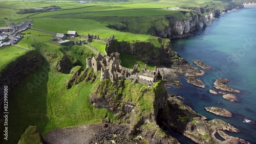 Aerial shot of Dunluce Castle, in Bushmills on the North County Antrim coast in Northern Ireland.

The camera begins wide and travels overhead.

Produced in 4K, 30fps and in Rec709 color. photo